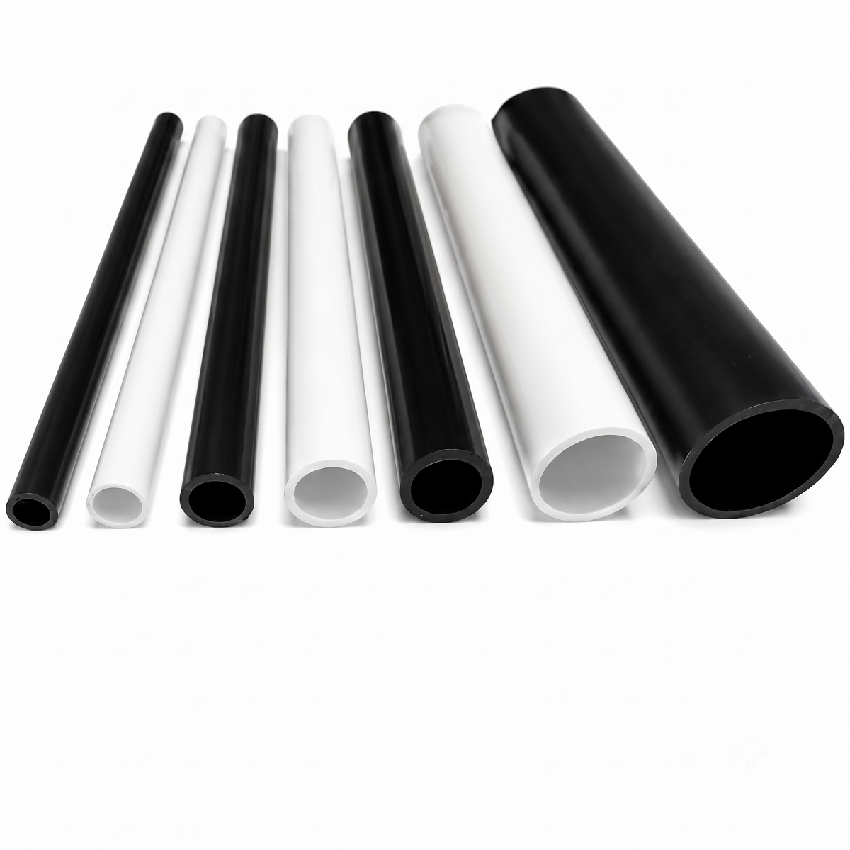 Rigid PVC round tubes in white and black, showing open bore ends and multiple sizes, UK made by Plastic Profile Supplies